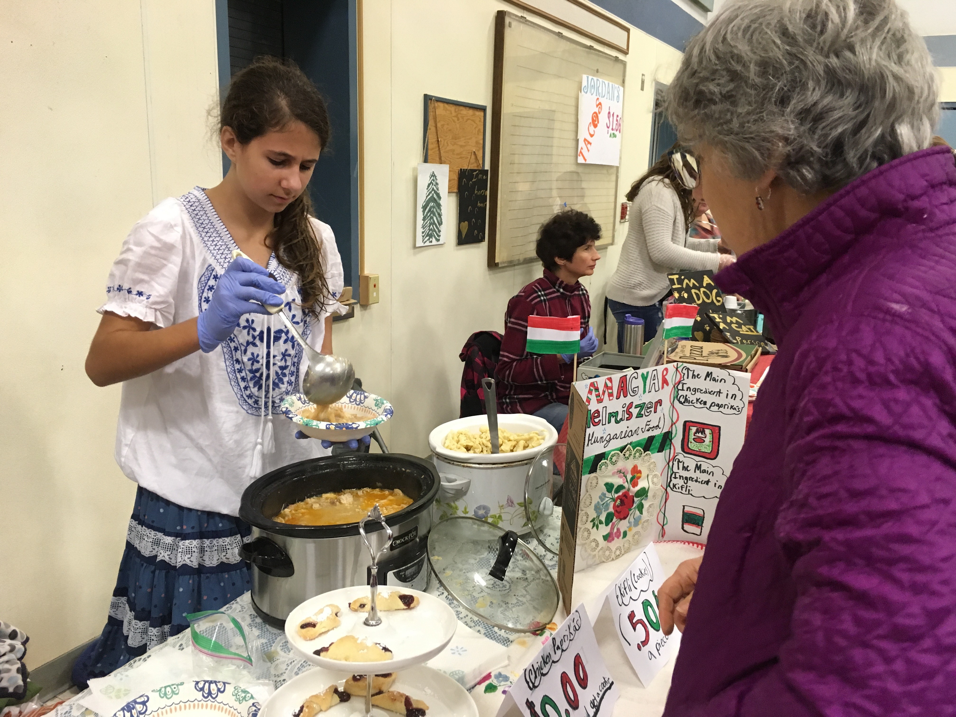 Chloe Messer, seventh grade, serving traditional Hungarian cuisine