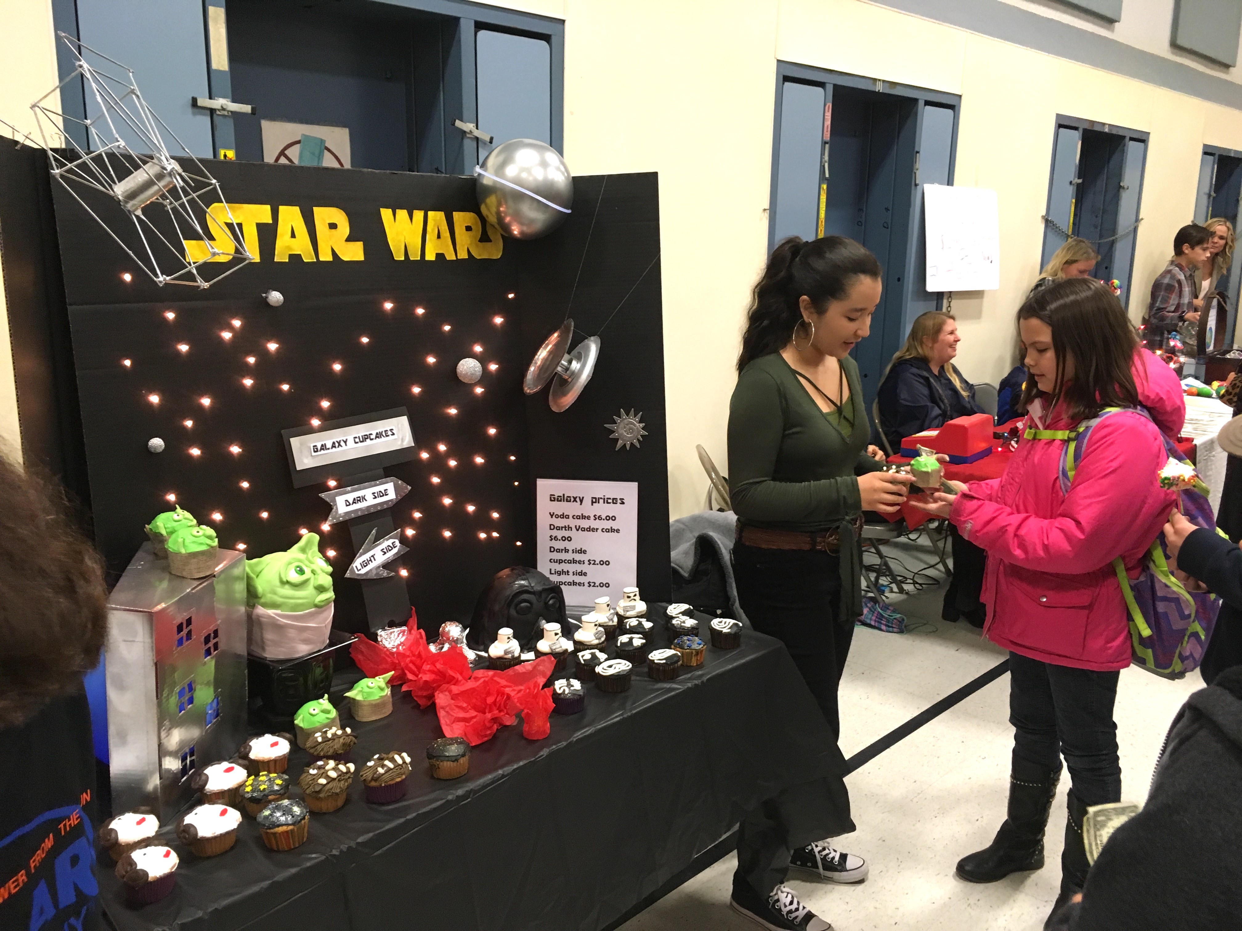 Olivia Kaihe, Best Marketing Winner, displaying her themed cupcakes