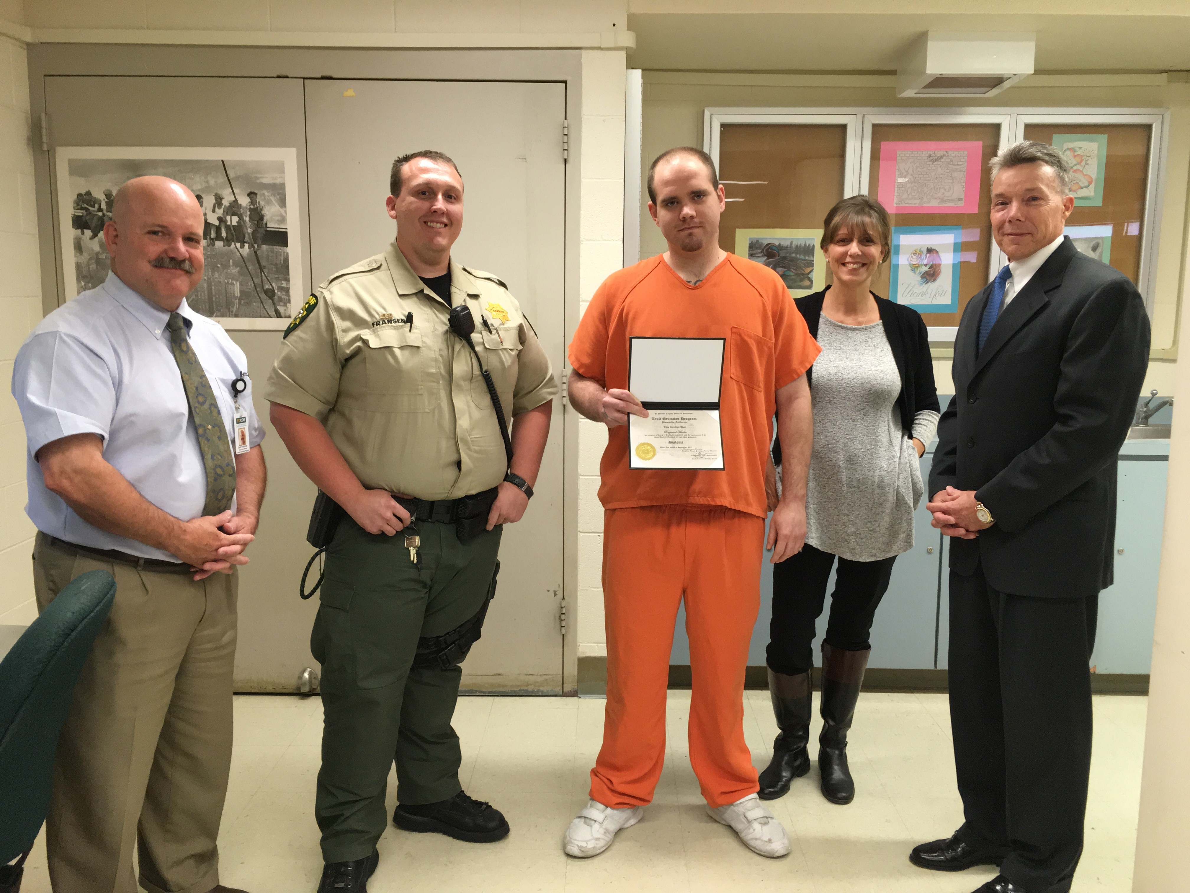 Left to right: David Publicover, Officer Fransen, Raymond Martin, Caroline Earl, and Gary Sutherland celebrate Martin earning his high school diploma