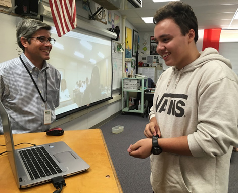 Senior Jalen Bush discusses common interests with a student in Nagano, Japan.