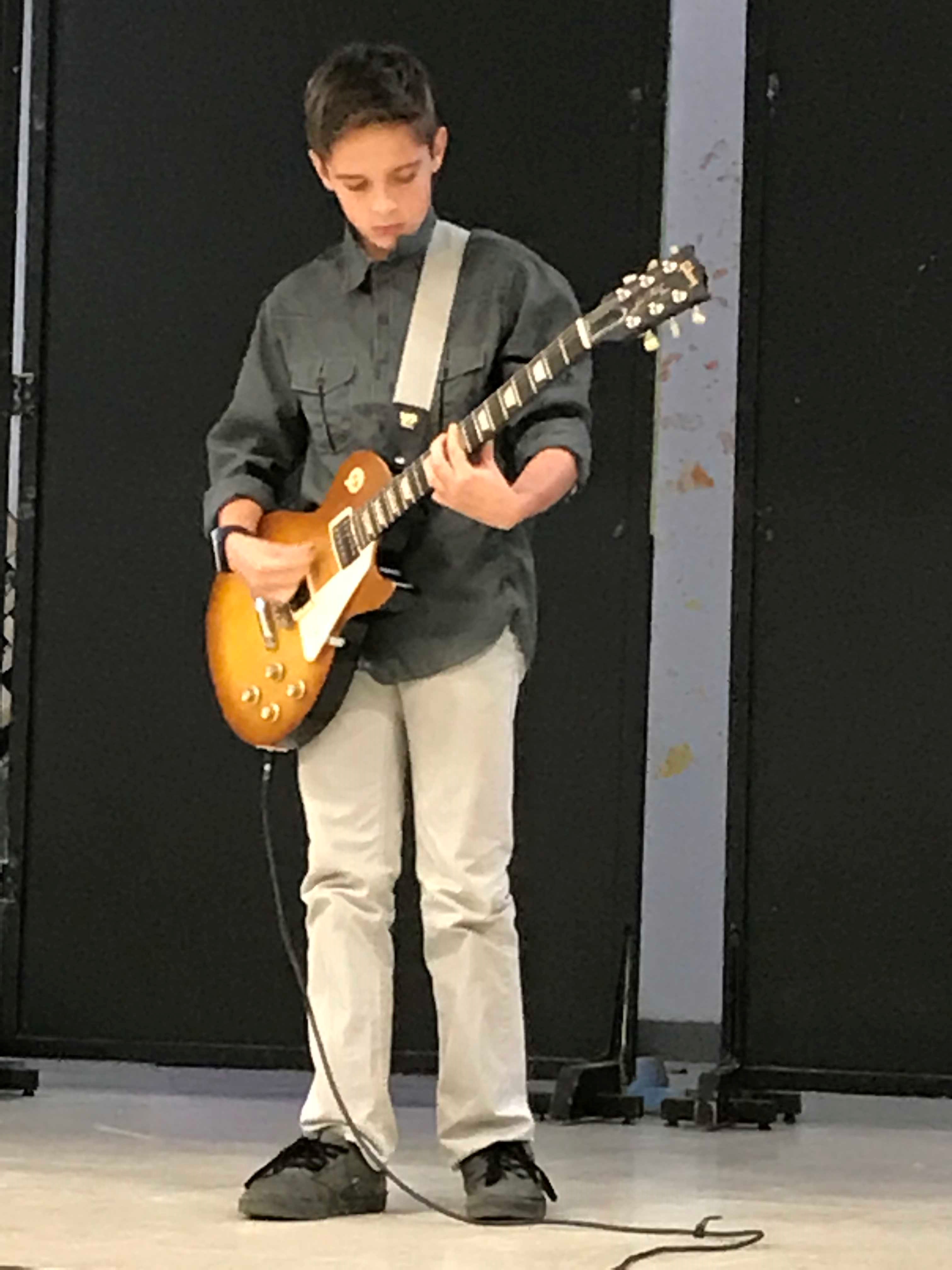 Student playing a guitar